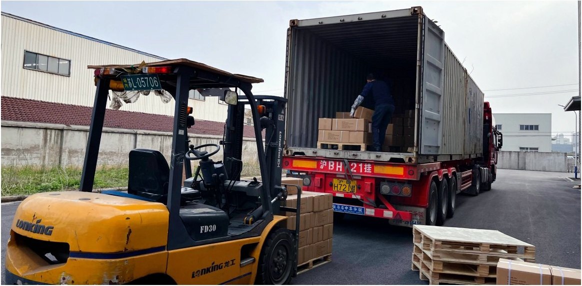 Loaded truck at the EXTRACUT dock with forklift alongside, ready to leave for the port